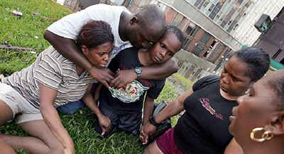 A family of Hurricane Katrina survivors prays