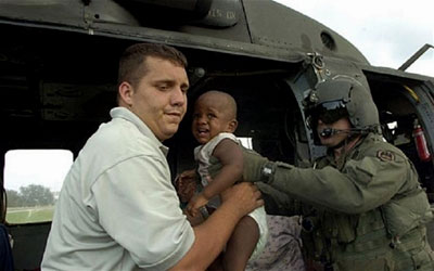 National Guard members transport a young boy
