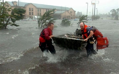 Two men fight the strong wind of Hurricane Katrina